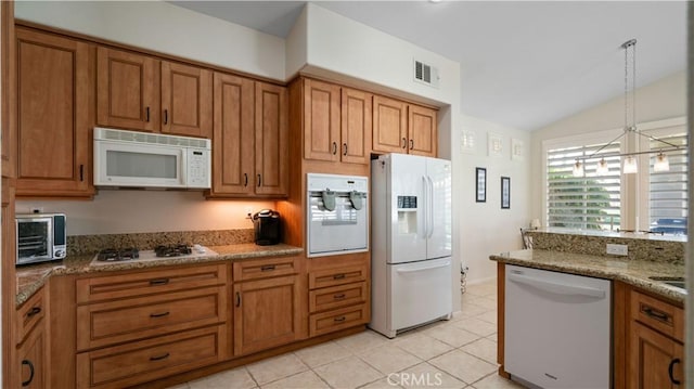 kitchen featuring visible vents, brown cabinets, white appliances, a toaster, and vaulted ceiling