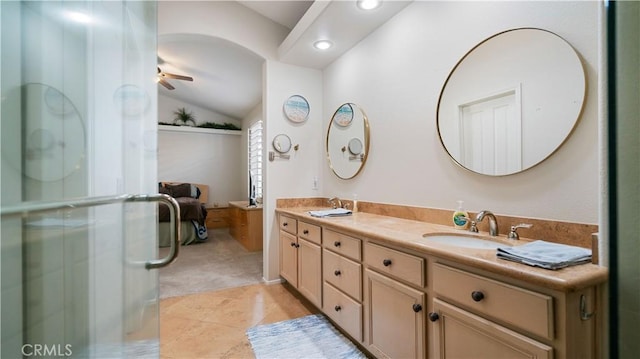 bathroom featuring tile patterned floors, a sink, double vanity, lofted ceiling, and ceiling fan