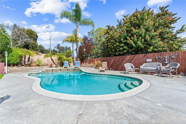 view of pool with a patio area, a fenced backyard, and a fenced in pool