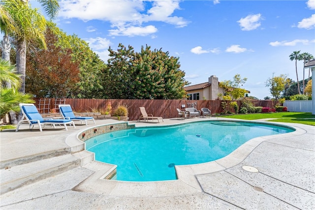 view of swimming pool with a patio, a fenced in pool, and a fenced backyard