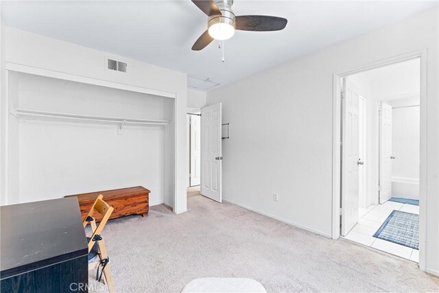 bedroom with visible vents, carpet floors, ceiling fan, a closet, and connected bathroom