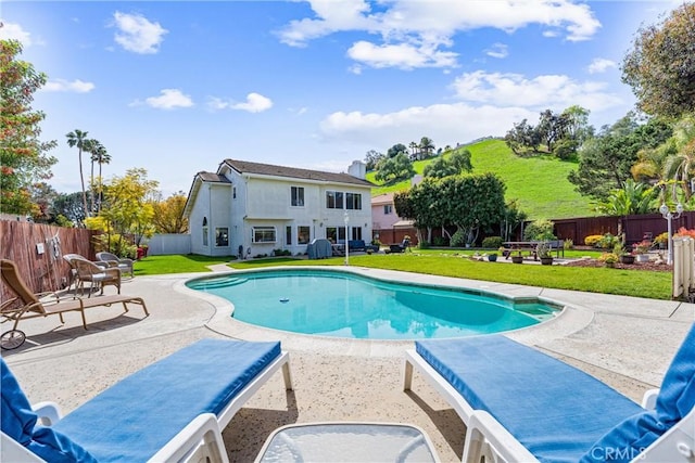 view of swimming pool with a fenced in pool, a lawn, a fenced backyard, and a patio area