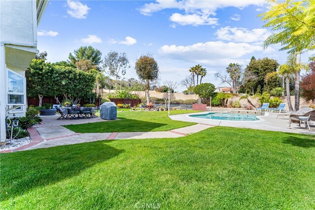 view of yard featuring a fenced in pool, a patio, and fence