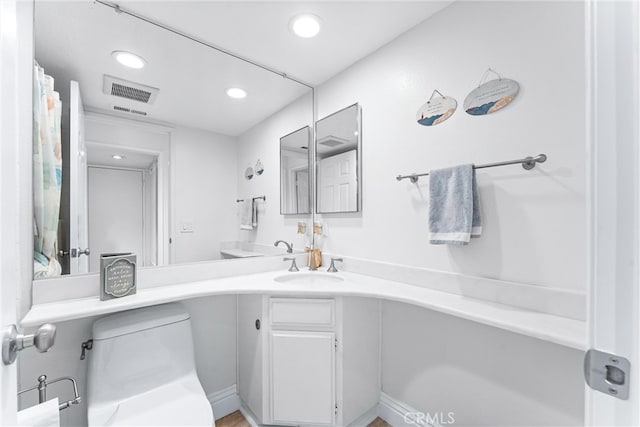 bathroom featuring visible vents, recessed lighting, and vanity