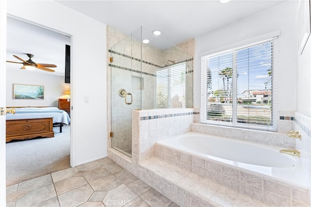 ensuite bathroom featuring ceiling fan, a shower stall, ensuite bathroom, a garden tub, and tile patterned floors