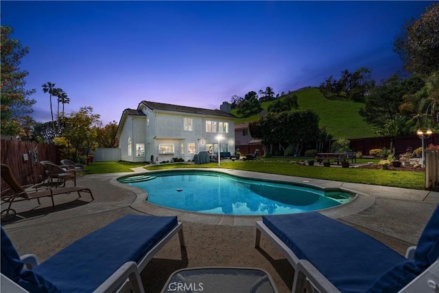 view of swimming pool featuring a lawn, a fenced backyard, and a patio area