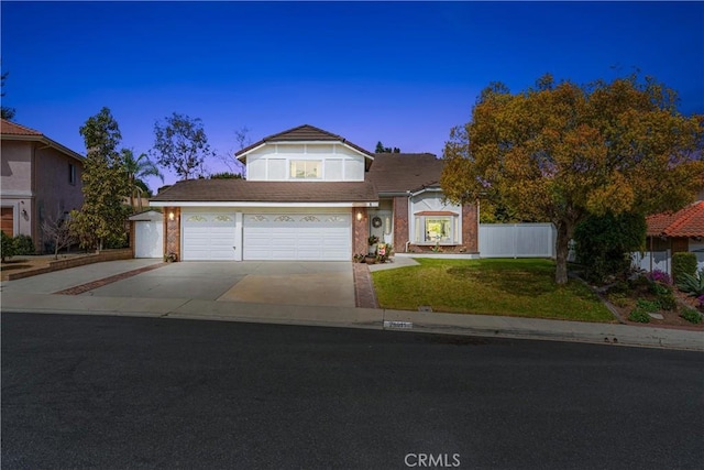 traditional-style house featuring a front lawn, concrete driveway, a garage, and fence