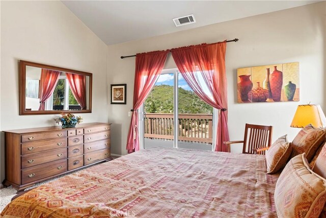 bedroom featuring vaulted ceiling, visible vents, and access to outside