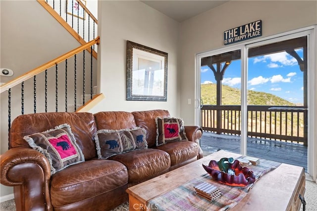 living area with carpet floors and stairs