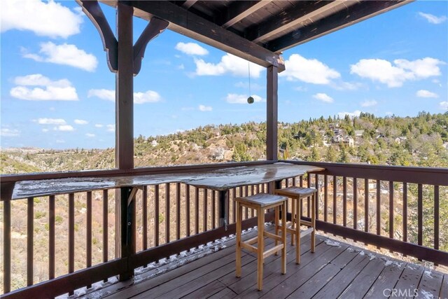 wooden deck featuring a view of trees