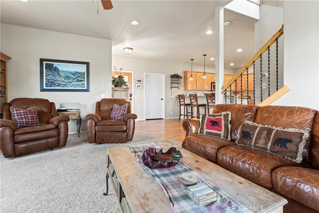 living room with a ceiling fan, recessed lighting, stairway, carpet flooring, and baseboards