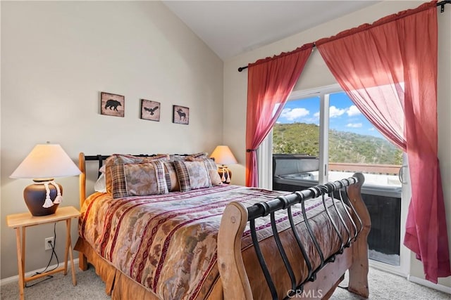 carpeted bedroom featuring vaulted ceiling, access to exterior, and baseboards