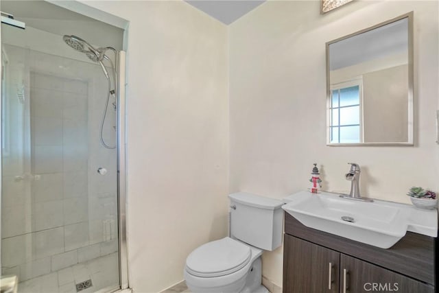 full bathroom featuring toilet, a stall shower, and vanity