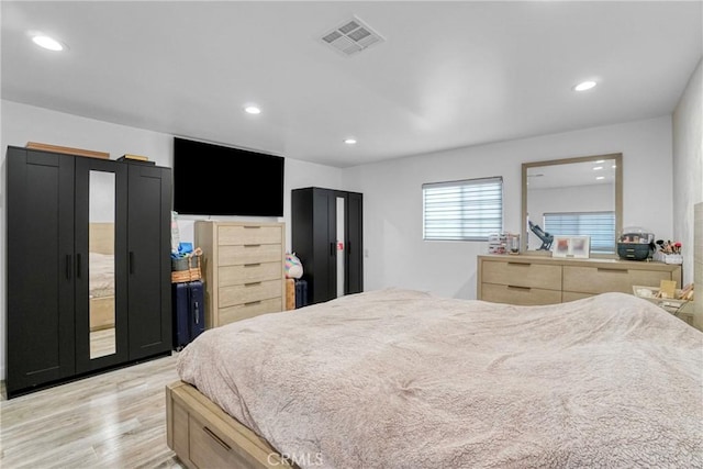 bedroom with recessed lighting, light wood-style floors, and visible vents