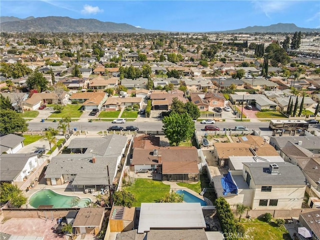 drone / aerial view featuring a residential view and a mountain view