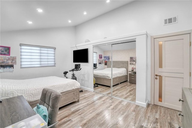 bedroom with vaulted ceiling, light wood-style flooring, recessed lighting, and visible vents