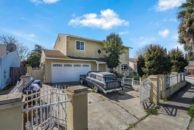 view of front of property with a fenced front yard, stucco siding, driveway, and an attached garage