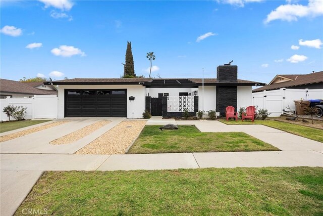 view of front of house with concrete driveway, fence, a garage, and a gate