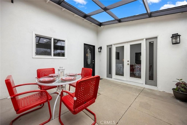 view of patio featuring a lanai, french doors, and outdoor dining area