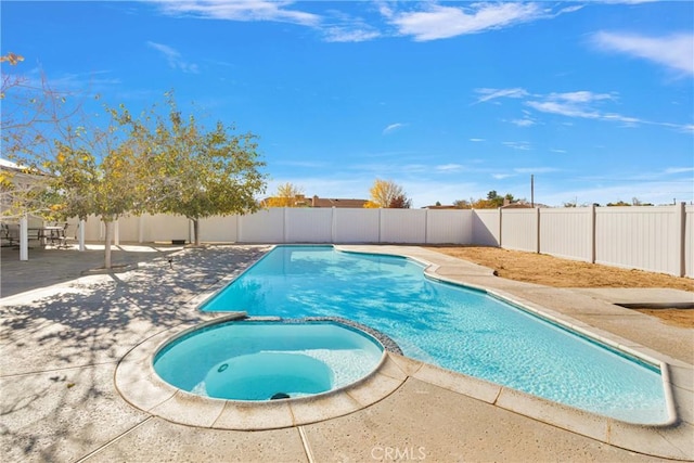 view of swimming pool with a patio, a fenced backyard, and a pool with connected hot tub