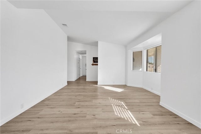 spare room with visible vents, baseboards, and light wood-style flooring