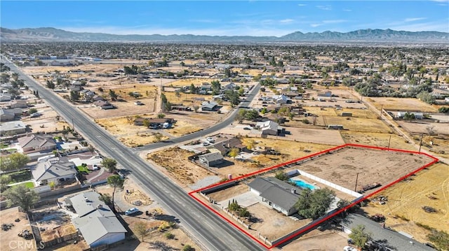 birds eye view of property with a desert view and a mountain view