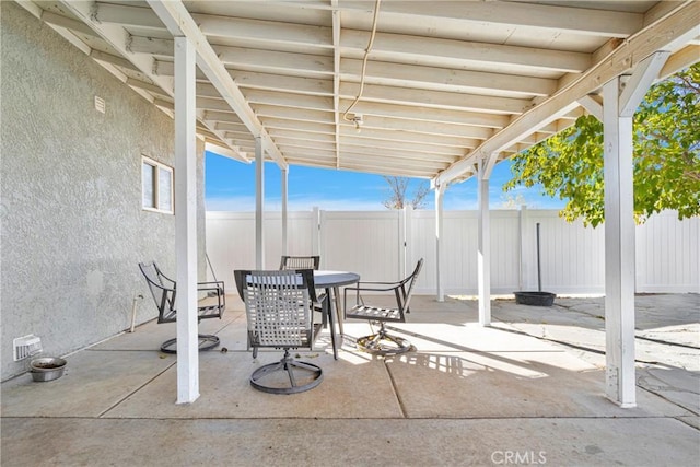 view of patio / terrace featuring outdoor dining space, a fenced backyard, and visible vents