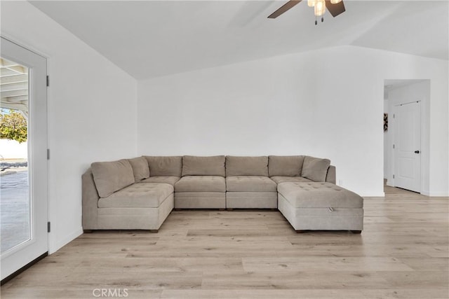 unfurnished living room with baseboards, lofted ceiling, ceiling fan, and light wood finished floors