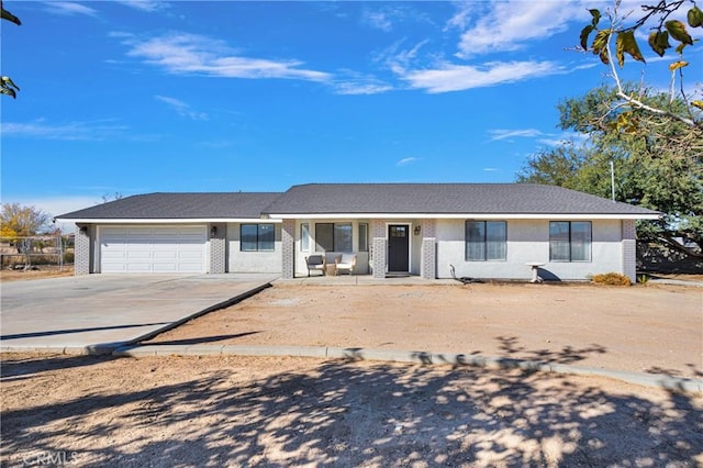 ranch-style home with brick siding, concrete driveway, and a garage