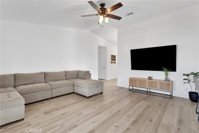 living area featuring light wood finished floors, visible vents, a ceiling fan, and lofted ceiling