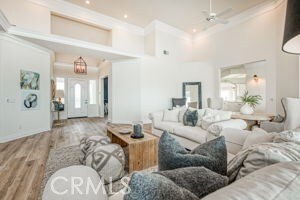 living room featuring a high ceiling and wood finished floors