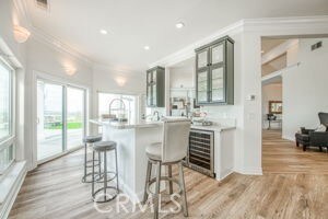 bar featuring recessed lighting, wine cooler, ornamental molding, and light wood finished floors