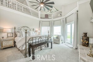 carpeted bedroom featuring a high ceiling