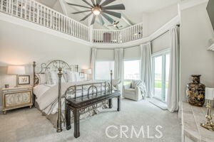 carpeted bedroom with a high ceiling