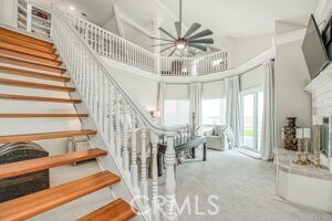 staircase featuring carpet, a towering ceiling, and a chandelier