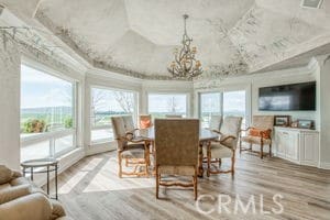 dining room featuring vaulted ceiling, a notable chandelier, plenty of natural light, and wood finished floors