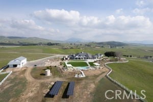 birds eye view of property with a rural view