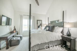carpeted bedroom featuring lofted ceiling