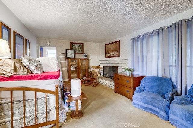 carpeted bedroom featuring a stone fireplace, a textured ceiling, and wallpapered walls