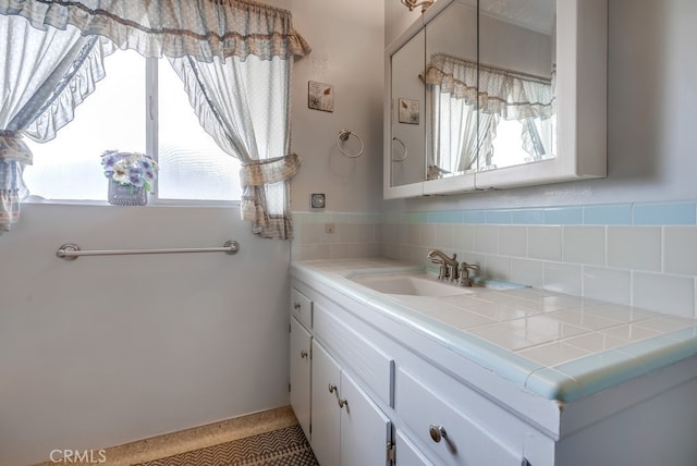 bathroom with backsplash and vanity