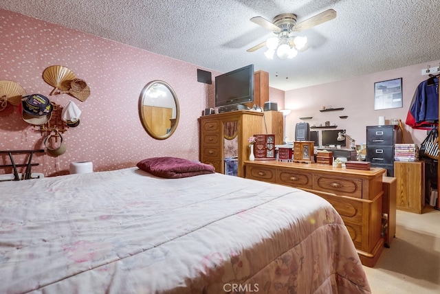 bedroom with light carpet, a textured ceiling, and wallpapered walls