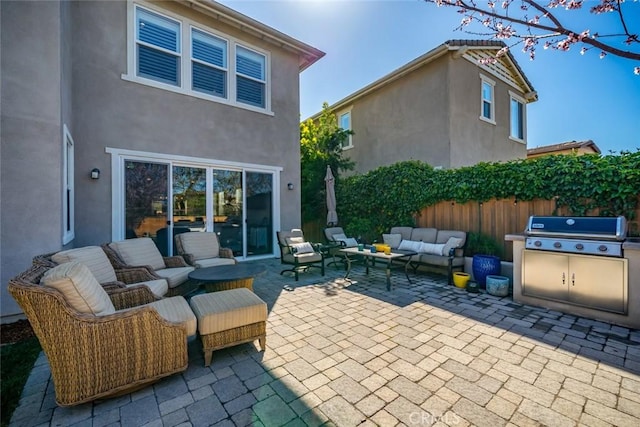 view of patio / terrace with area for grilling, outdoor lounge area, and fence