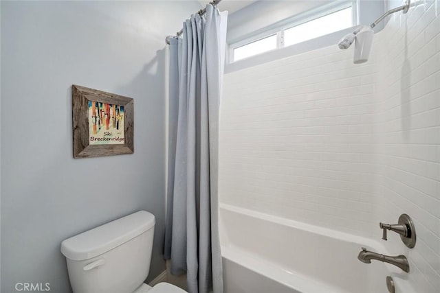 bathroom with toilet and shower / bath combo with shower curtain