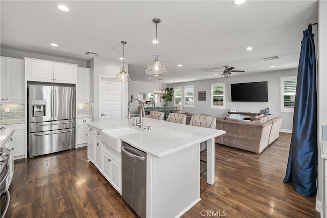 kitchen featuring visible vents, dark wood finished floors, ceiling fan, a sink, and appliances with stainless steel finishes