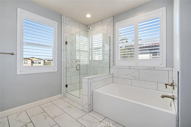 full bath with plenty of natural light, a bath, baseboards, and marble finish floor