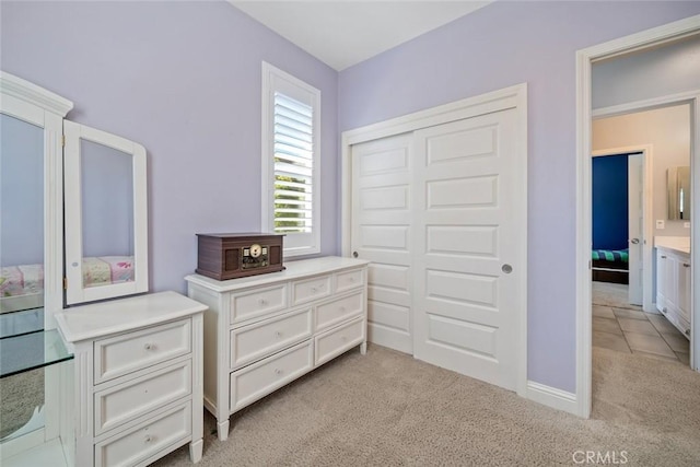 bedroom with a closet and light colored carpet