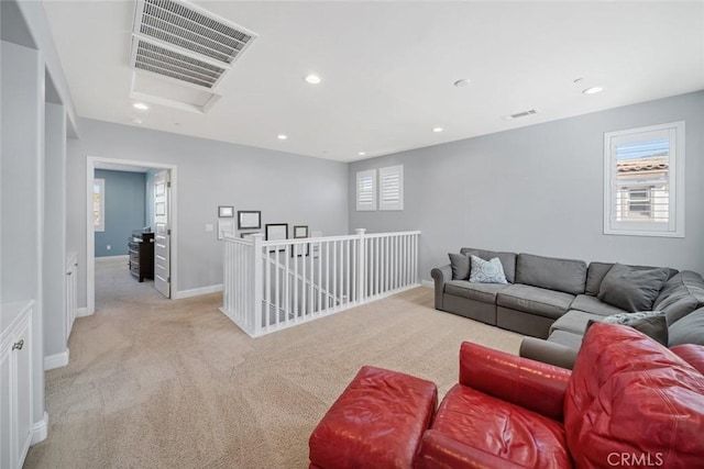 carpeted living room featuring recessed lighting, visible vents, a wealth of natural light, and baseboards