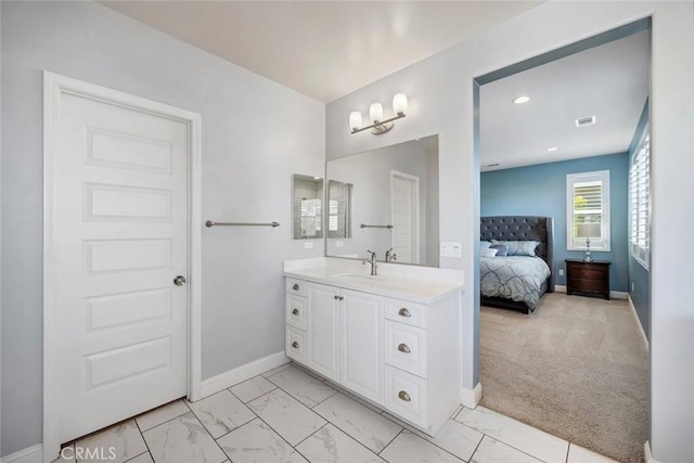 bathroom featuring baseboards, vanity, recessed lighting, marble finish floor, and ensuite bath