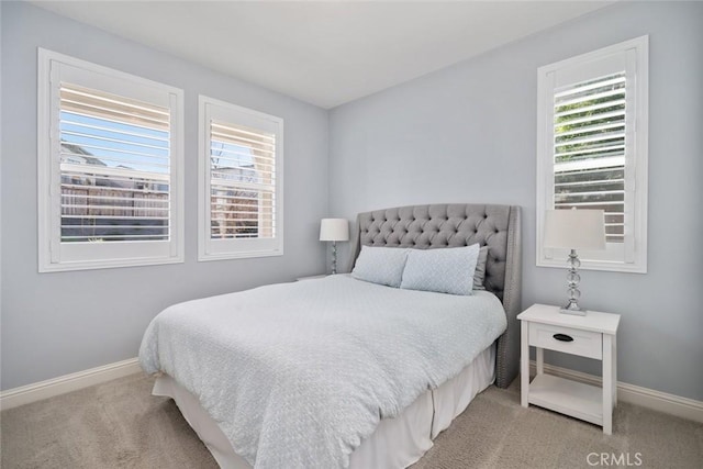 carpeted bedroom featuring baseboards