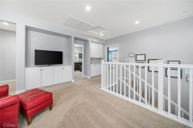 sitting room featuring recessed lighting, baseboards, an upstairs landing, and light colored carpet